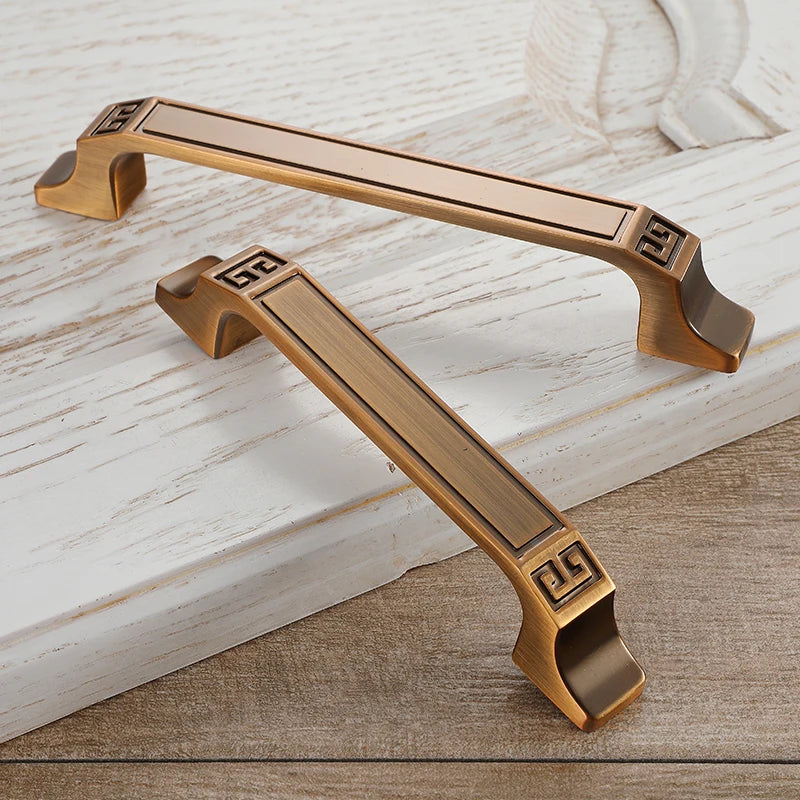 Vintage Cabinet Handles 2 bronze vintage handles on white cabinet