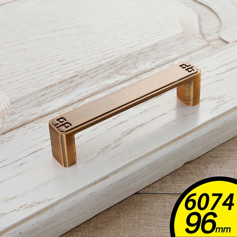 Antique brass finish Vintage Cabinet Handles with decorative corner design on white wooden cabinet