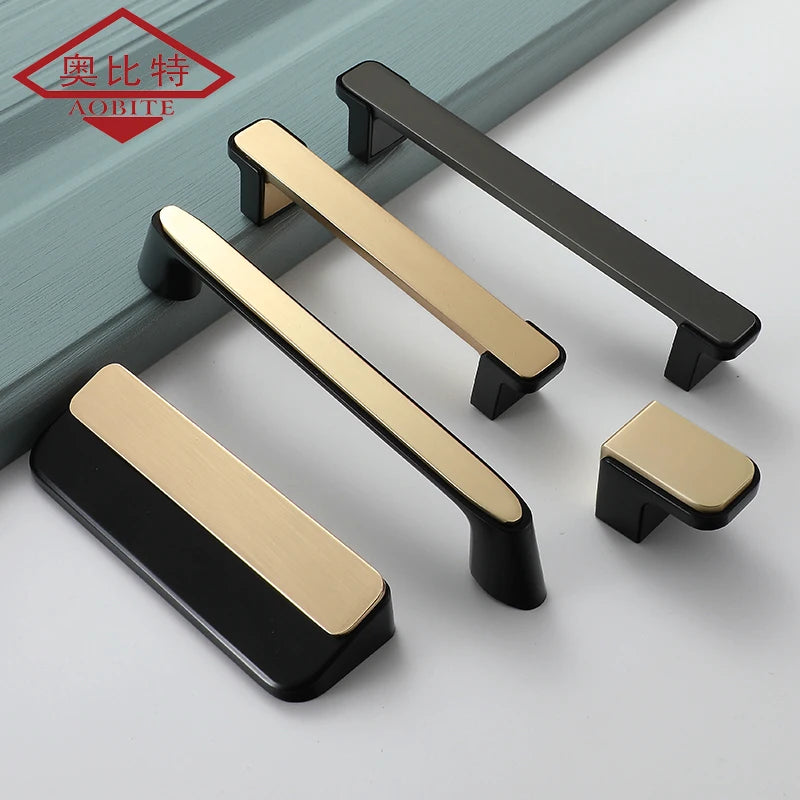 Luxury kitchen cabinet handles in gold and black with a modern design displayed on a light surface.