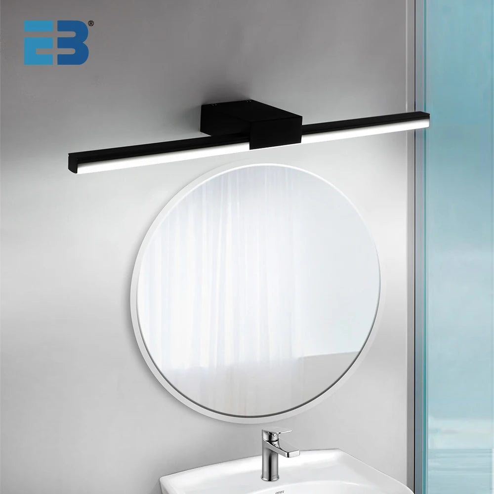 Modern LED bathroom vanity light with sleek black finish mounted above a round mirror in a contemporary bathroom setting.