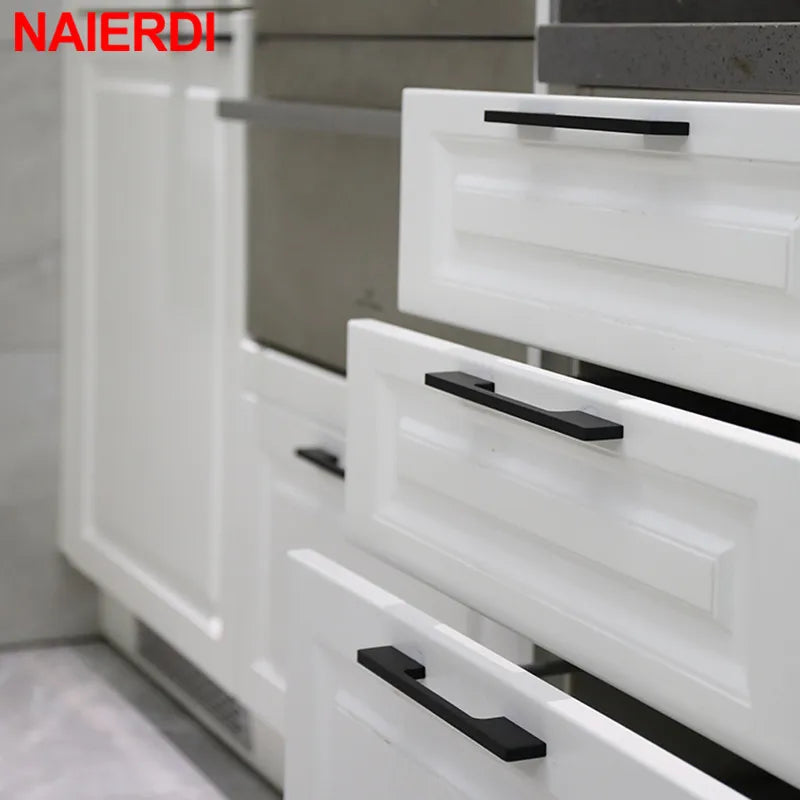 NAIERDI matte black cabinet door handles on white drawers in a modern kitchen setting, available in 800mm and 1000mm sizes.