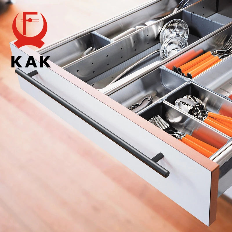 KAK 24-inch black T-bar kitchen door handle on a white drawer with organized cutlery, emphasizing sleek design and functionality.