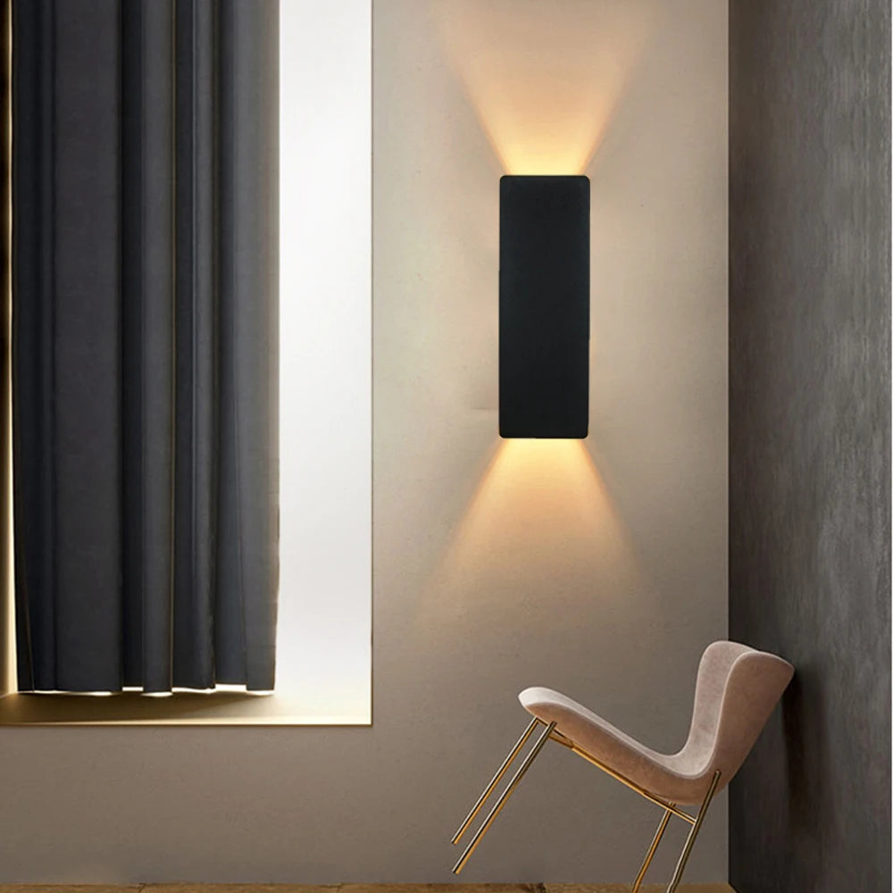 Modern LED wall lamp with black rectangular design providing ambient lighting in a stylish room setting.