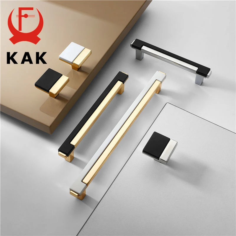 Gold and chrome cabinet handles in modern design with black and white accents.