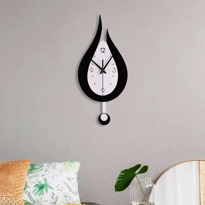 Waterdrop swinging wall clock in black and white acrylic, mounted on a gray wall, ideal for living room or bedroom decor.