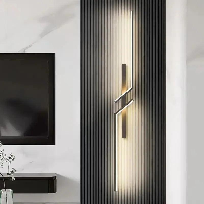 Modern minimalist LED wall sconce with strip lighting on a dark textured panel in a stylish living room.