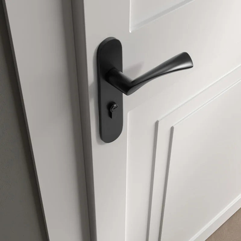 Black American style indoor door lock with integrated magnetic silent wooden door handle on a white door.