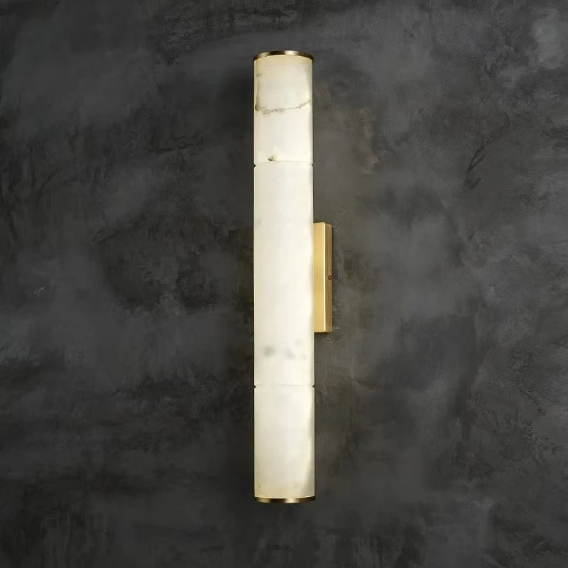 Luxurious marble wall lamp with gold accents on dark gray background, perfect for modern decor.