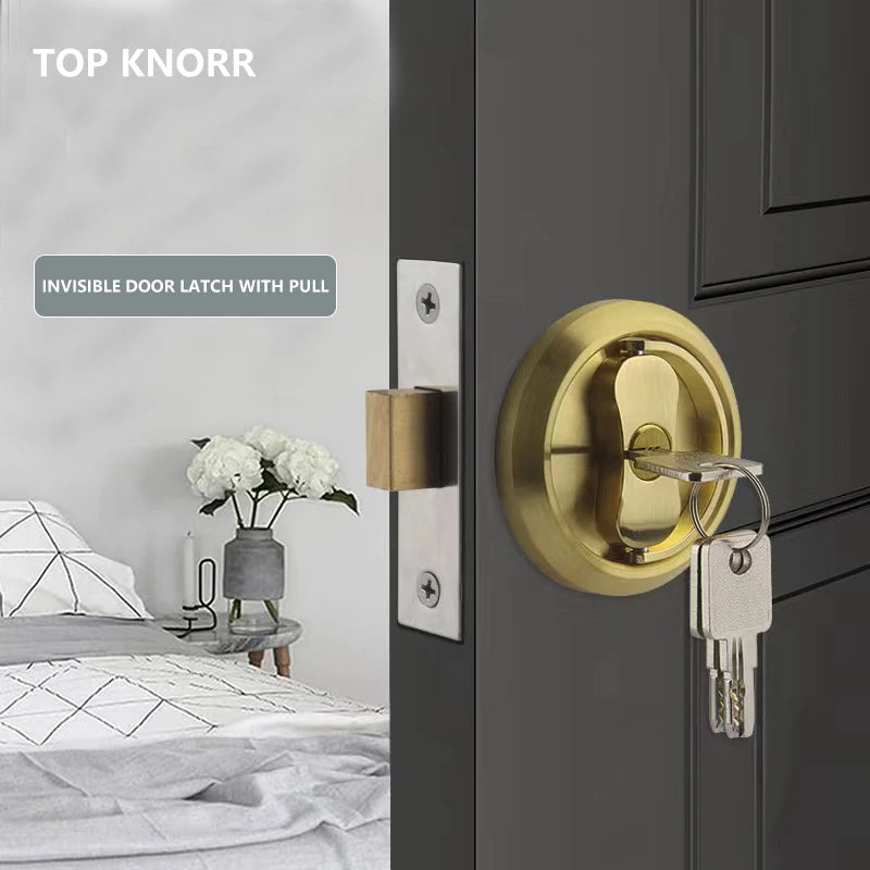 304 stainless steel invisible door lock with keys in a gold finish on a dark door, set against a bedroom background.