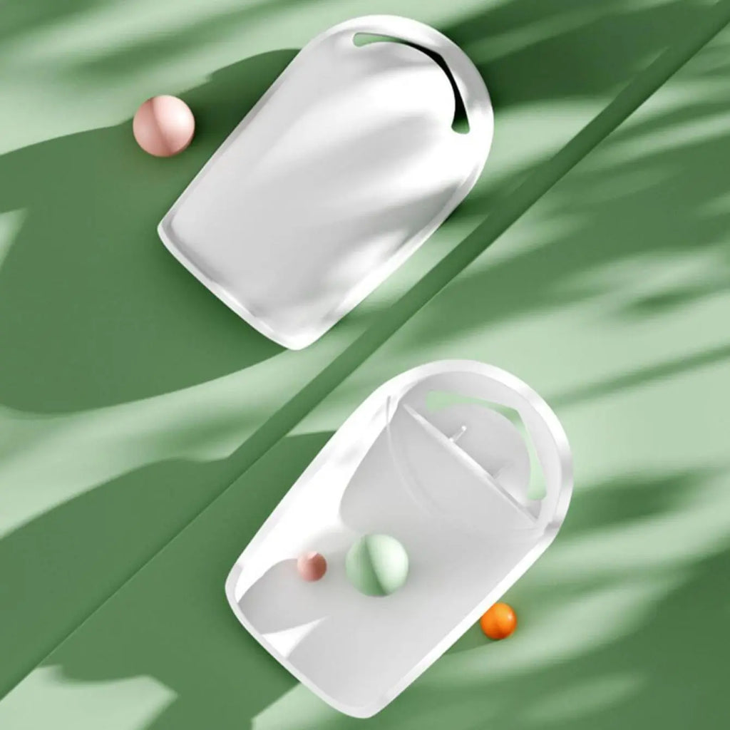 White water-saving faucet extender for kids, placed on a light green surface with colorful spheres.