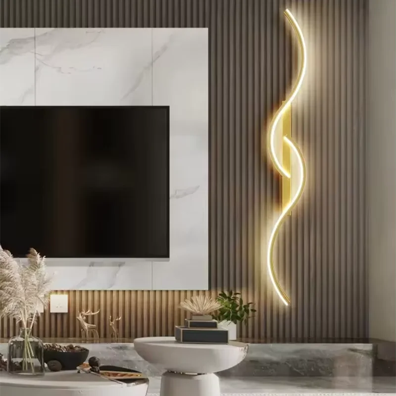 Modern LED wall lamp with a minimalist long strip design, emitting warm light, mounted in a stylish living room setting.