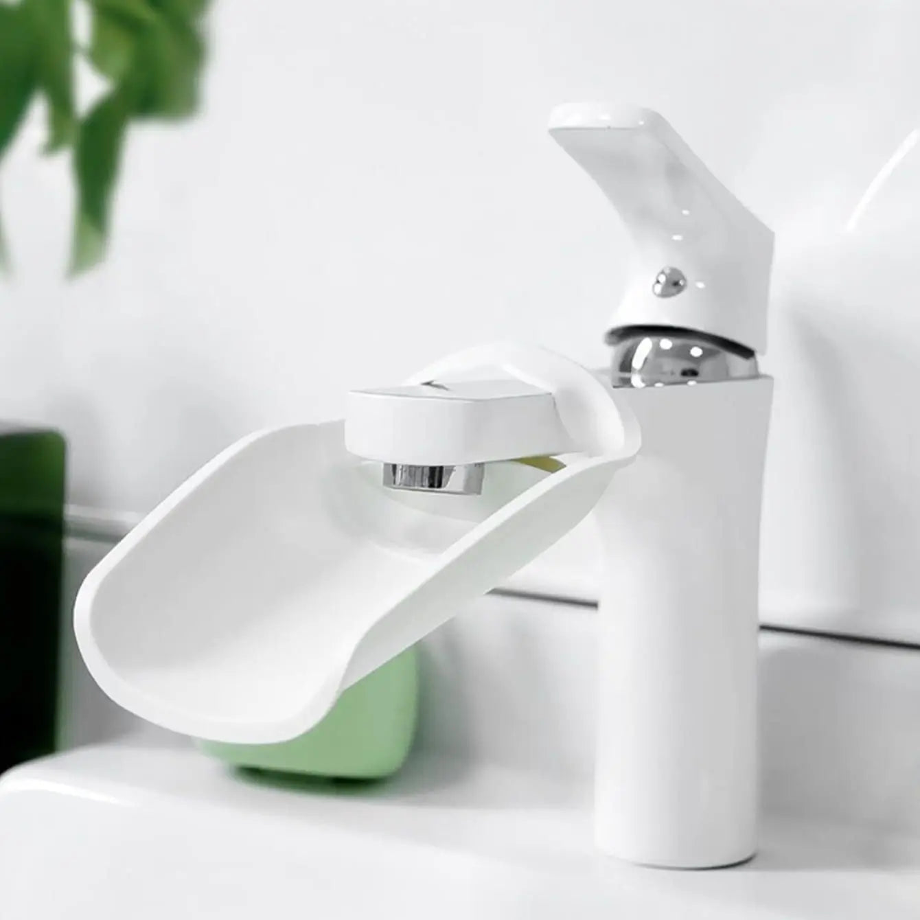 White water-saving nozzle faucet extender attached to a bathroom sink, aiding in easy hand washing for kids.