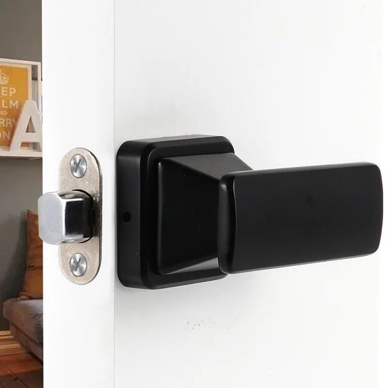 Invisible black door handle with anti backlock feature on a white door, shown in a modern interior setting.