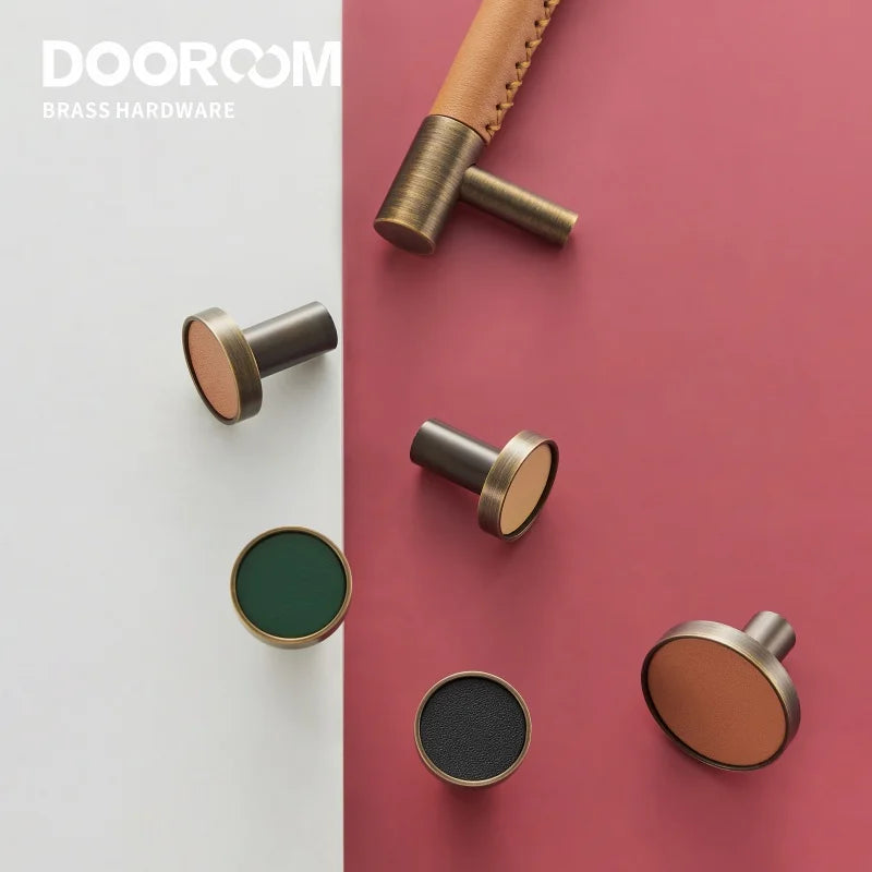 Dooroom brass furniture handles with real leather accents in Nordic design on a white and red background.