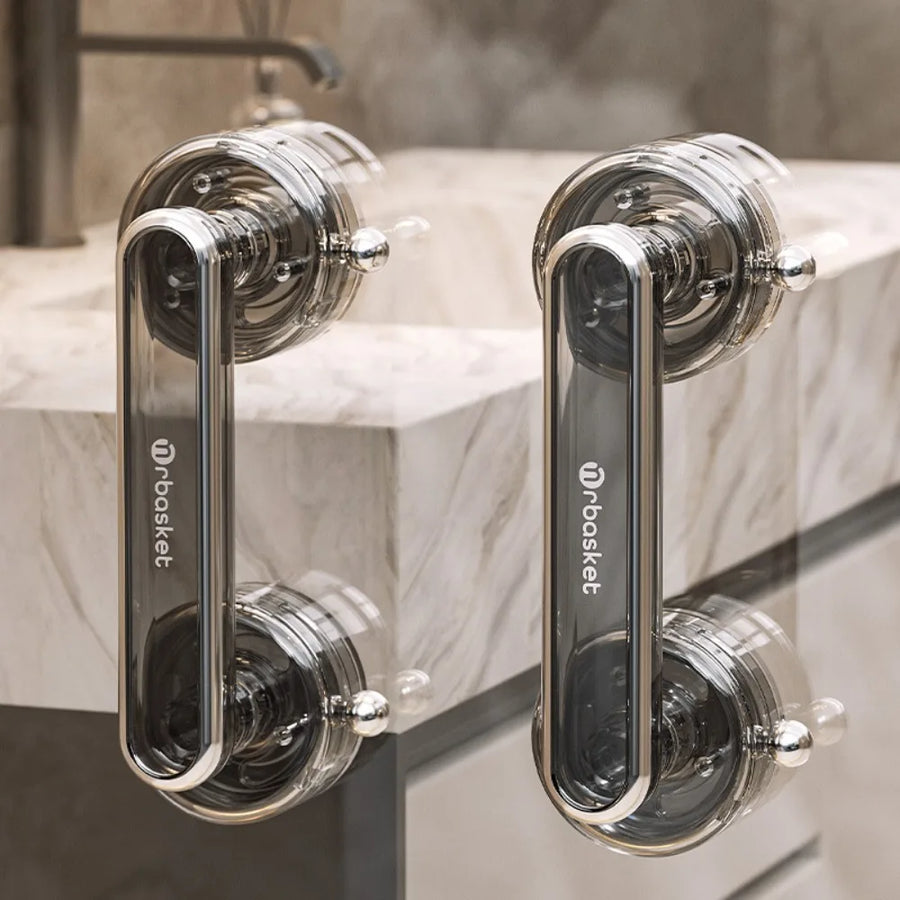 Chrome anti-slip sliding door handles with suction cups attached to marble surface in a bathroom setting.