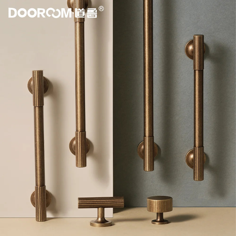 Dooroom vintage style brass furniture handles with ribbed detailing displayed against a neutral background.