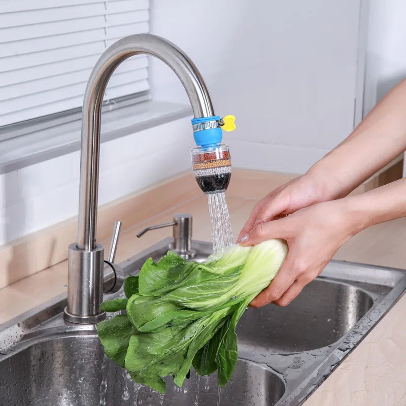 6-layer water filter tap purifier with medical stone and coconut charcoal attached to a kitchen faucet, shown filtering water over leafy greens.