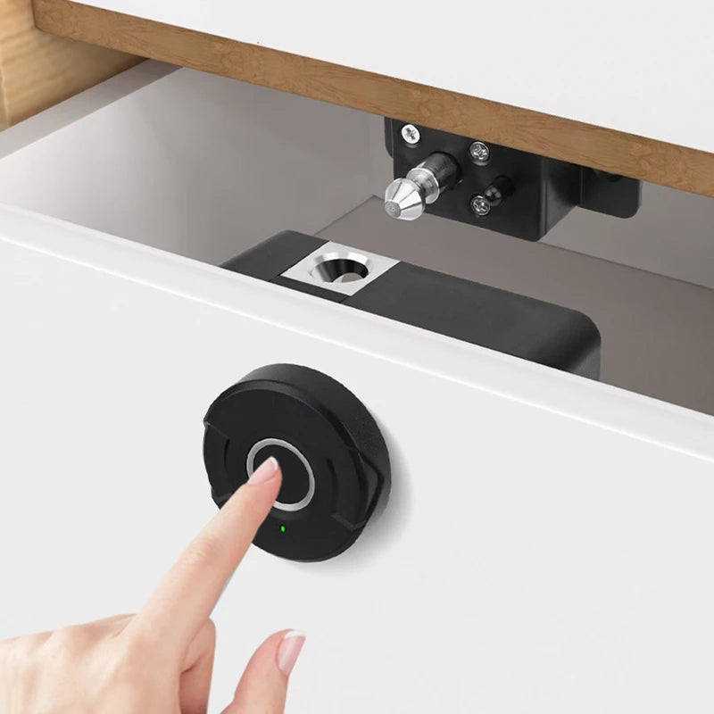 Keyless electric fingerprint lock on a white drawer with a hand using the sensor.