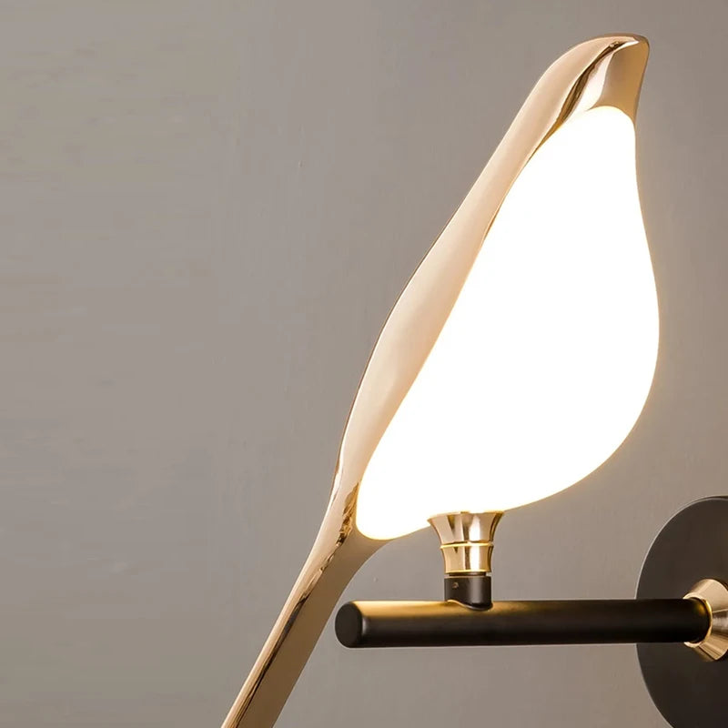 Nordic Golden Bird LED Wall Light with a sleek black base, offering modern elegance and warm diffused lighting.