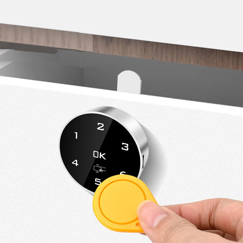 Touch keypad digital password lock with RFID IC card compatibility mounted on a white drawer, with a hand holding a yellow RFID card.