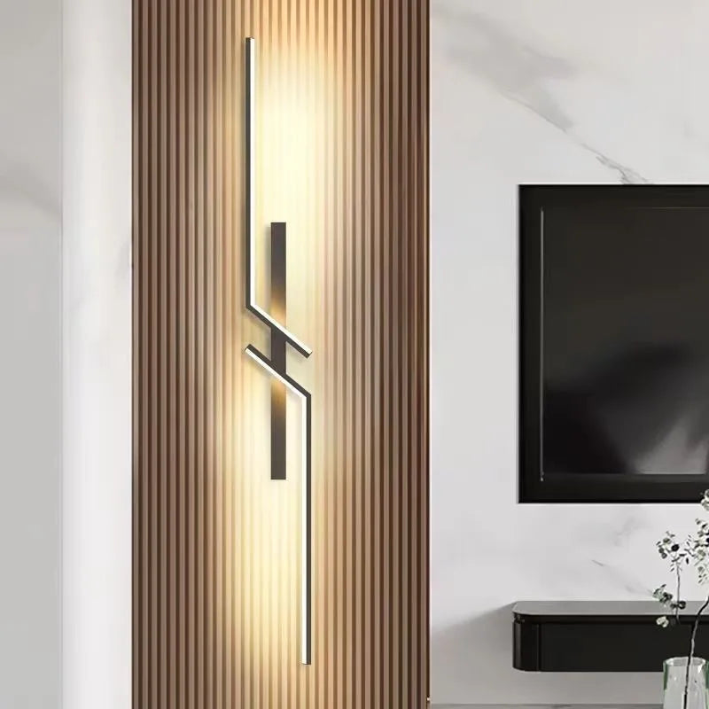 Modern minimalist LED wall lamp on a wooden panel in a stylish living room setting.