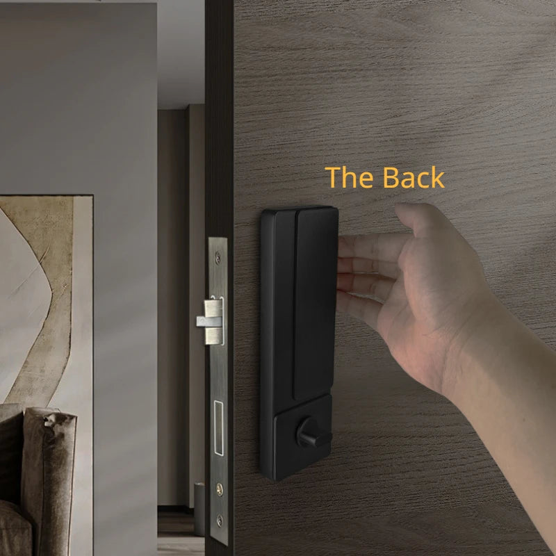 Invisible ultra-thin black lock on a wooden door with a hand reaching out, ideal for indoor bedroom and bathroom use.