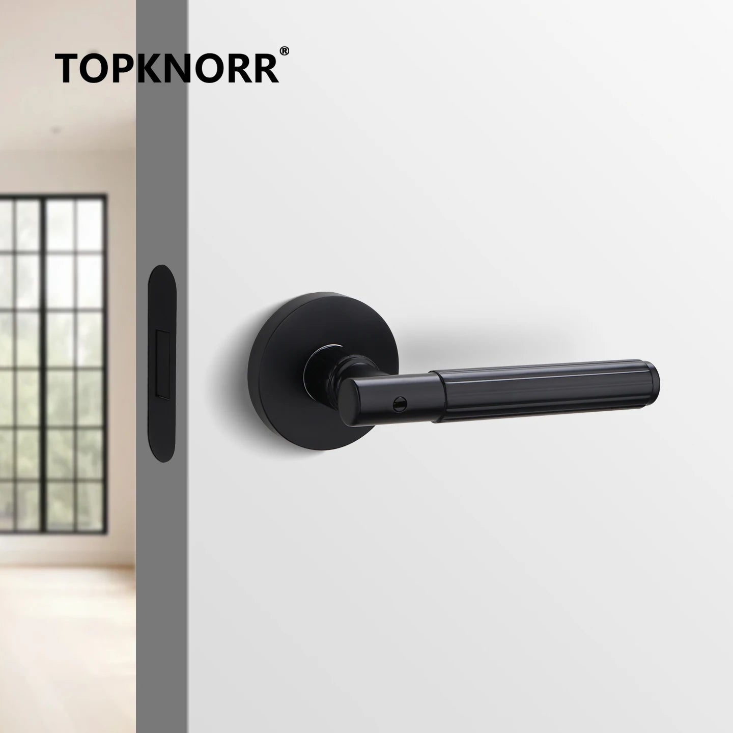 Black magnetic mute door lock handle on a white door with modern minimalist design.