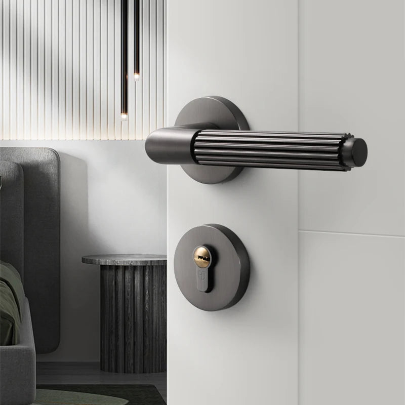 Modern black gray brushed wire bedroom door lock and handle on a white wooden door in a stylish interior.