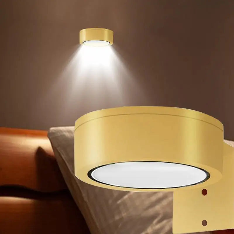 LED magnetic wall sconce with gold housing, featuring remote control and 13-color RGB lighting, mounted in a bedroom setting.