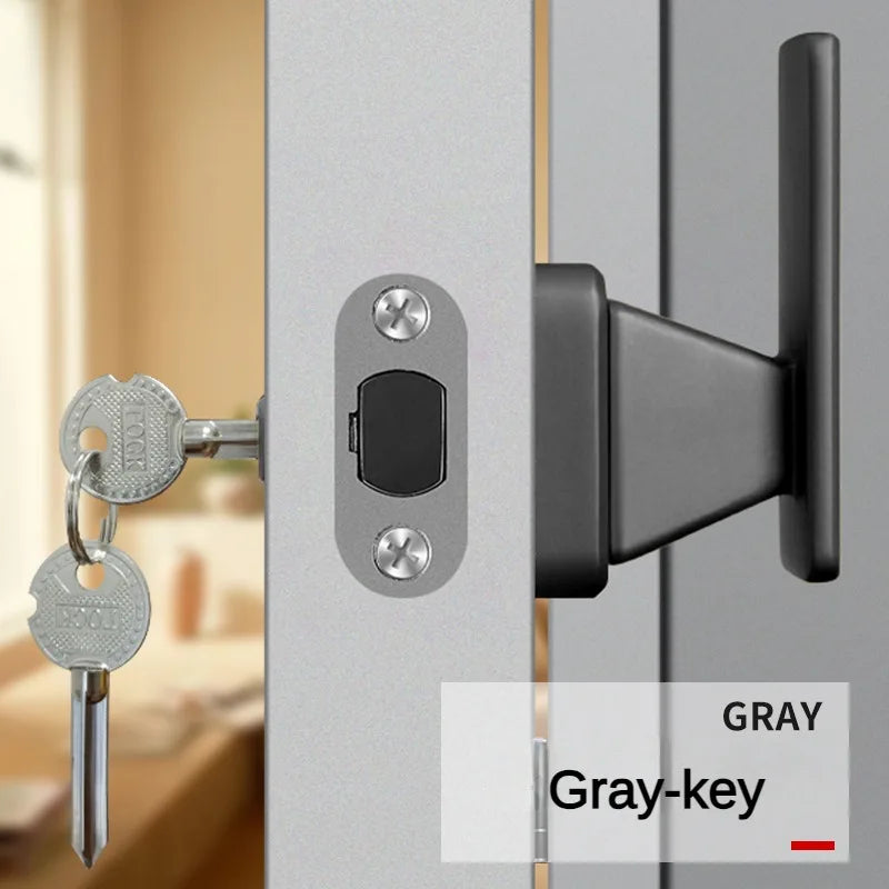 Invisible door handle with anti-backlock and single side lock in gray with keys, installed on a wooden door.