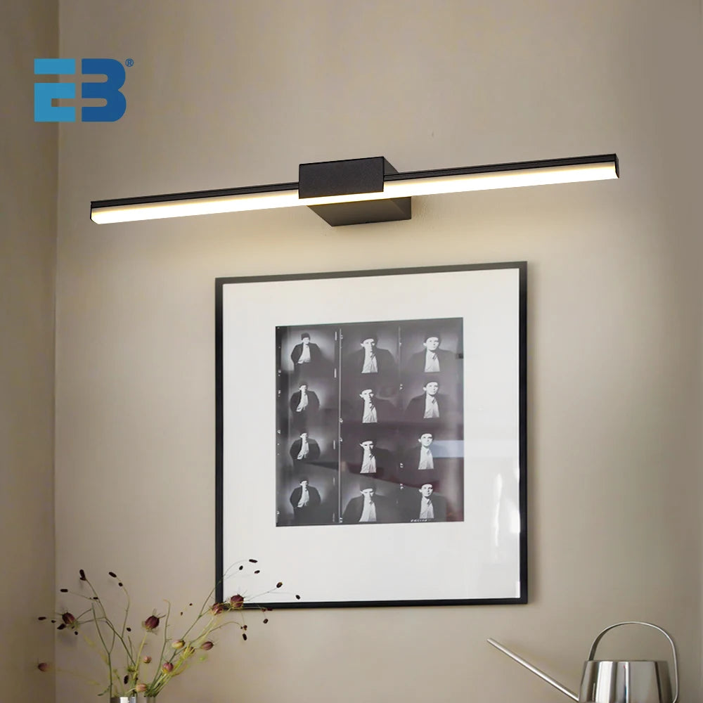 Modern LED bathroom vanity light mounted above framed artwork with sleek black finish and minimalist design.