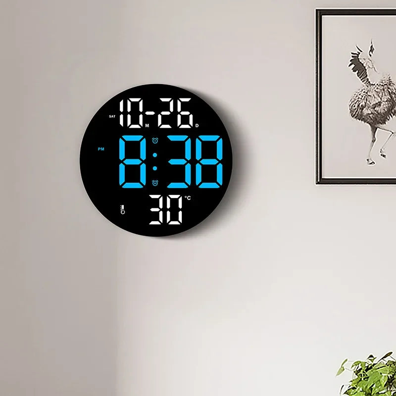 10-inch LED digital wall clock with dual alarms, calendar, and temperature display, mounted on a wall in a modern interior setting.