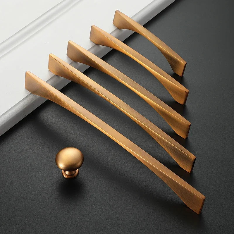 Set of classical antique cabinet handles and knob in yellow bronze finish on dark background