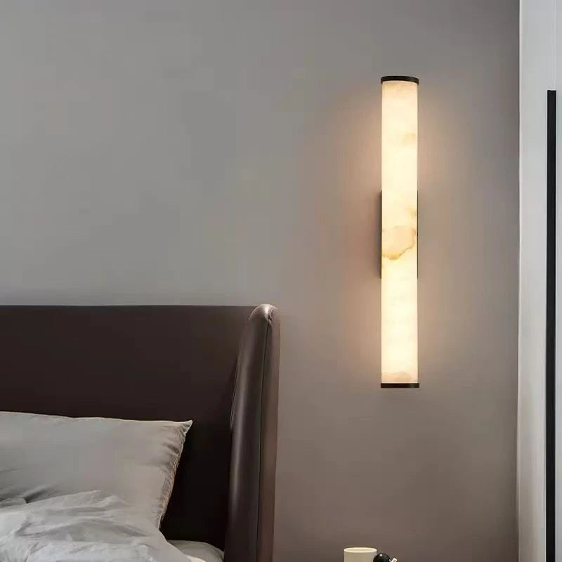 Luxurious marble wall lamp with warm light in a modern bedroom setting