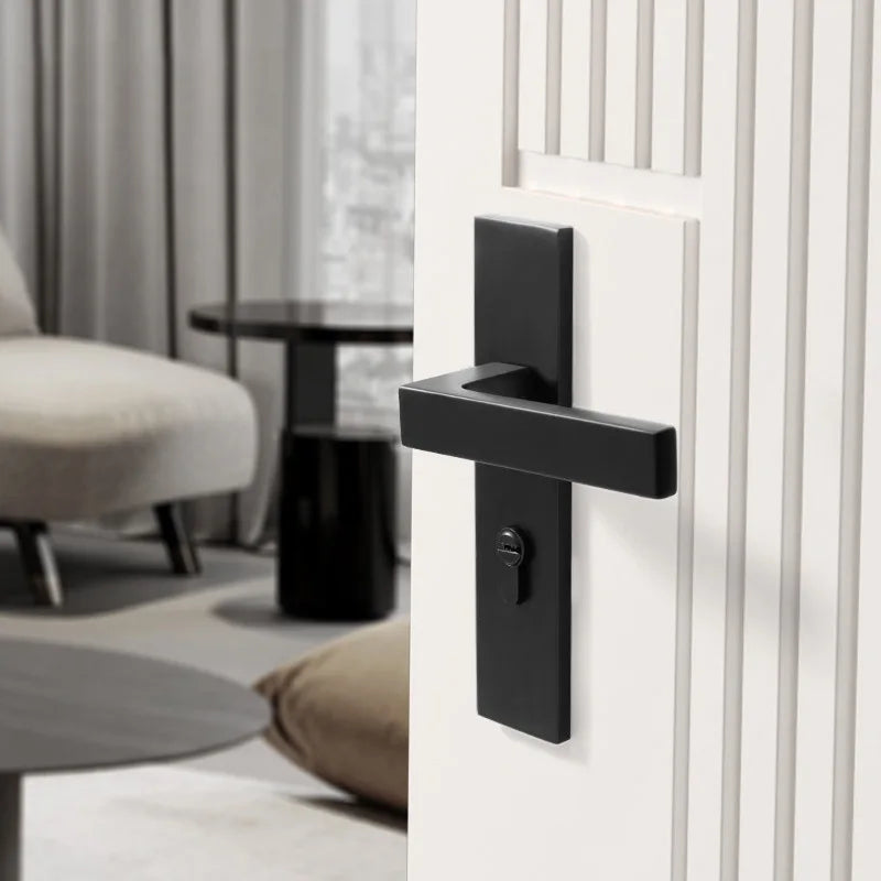 Black American style indoor door lock with integrated magnetic silent wooden handle on a white paneled door in a modern living room setting.
