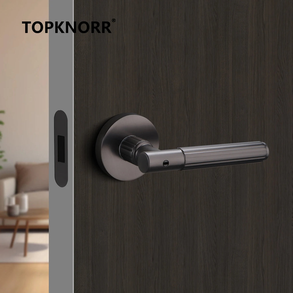 Modern black magnetic mute door lock on a wooden indoor door with a sleek handle, suitable for bathrooms and bedrooms.