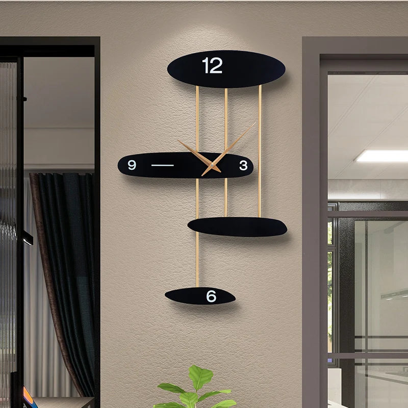 Modern light luxury wall-mounted clock with black ovals and gold accents, featuring minimalist and creative design set against a beige wall.